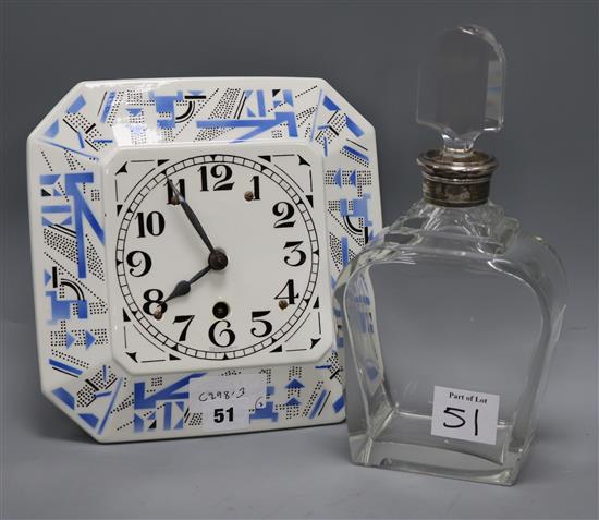 A German porcelain clock and a silver mounted decanter